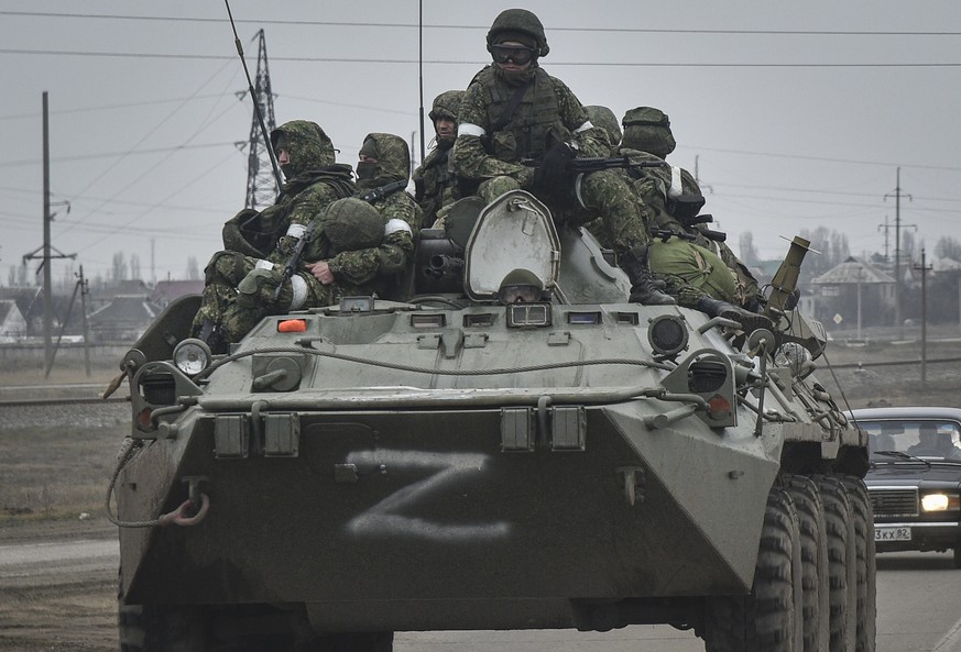 epa09784383 Russian soldiers on the armoured personnel carrier BTR-80 move towards mainland Ukraine on the road near Armiansk, Crimea, 25 February 2022. Russian troops entered Ukraine on 24 February p ...