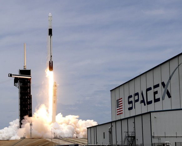 A SpaceX Falcon 9 rocket with a Dragon 2 spacecraft lifts off on pad 39A at the Kennedy Space Center for a re-supply mission to the International Space Station from Cape Canaveral, Fla., Thursday, Jun ...