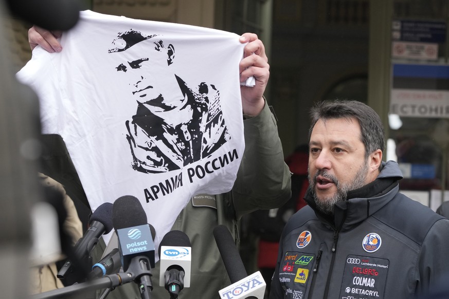 The Mayor of Przemysl, Wojciech Bakun, left, holds up a t-shirt with the likeness of Russian President Vladimir Putin and the words &quot;The Russian Army&quot; as Italy&#039;s League Party leader, Ma ...