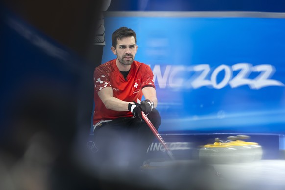 Switzerland skip Peter De Cruz directs his teammates during the men's Round Robin #3 game between Switzerland and Team ROC (Russia) at the National Aquatics Centre at the 2022 Olympic Winter Game ...