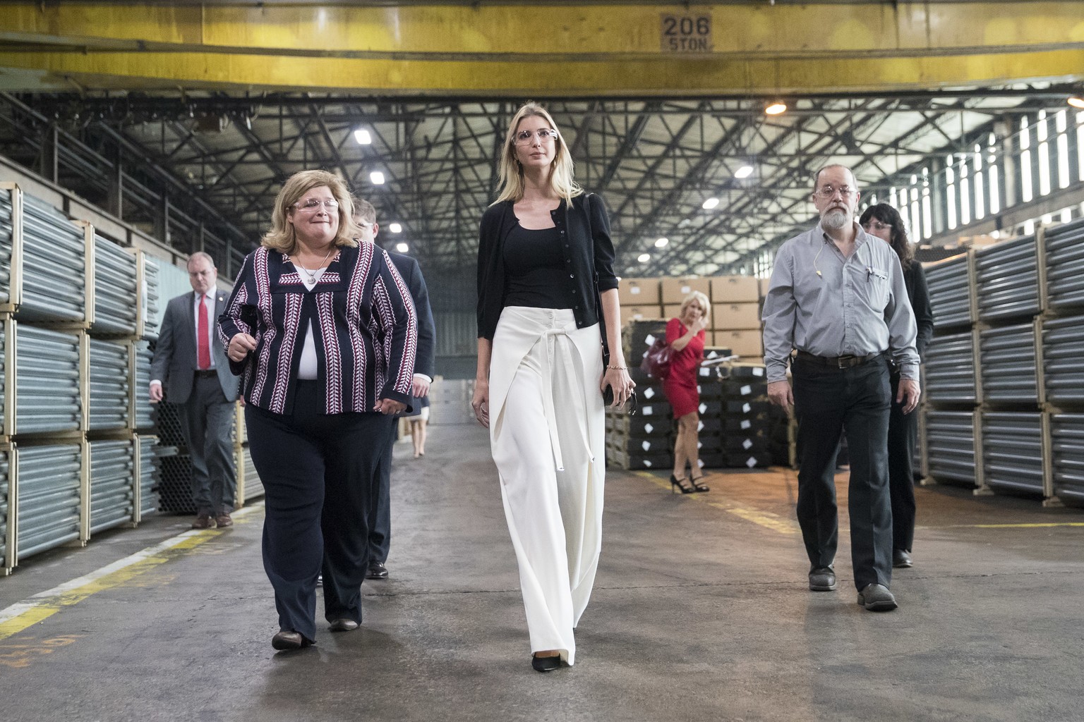 Ivanka Trump, daughter of Republican presidential candidate Donald Trump, center, tours Middletown Tube Works, a welded steel tube supplier, alongside owner Angela Phillips, left, Thursday, Oct. 6, 20 ...