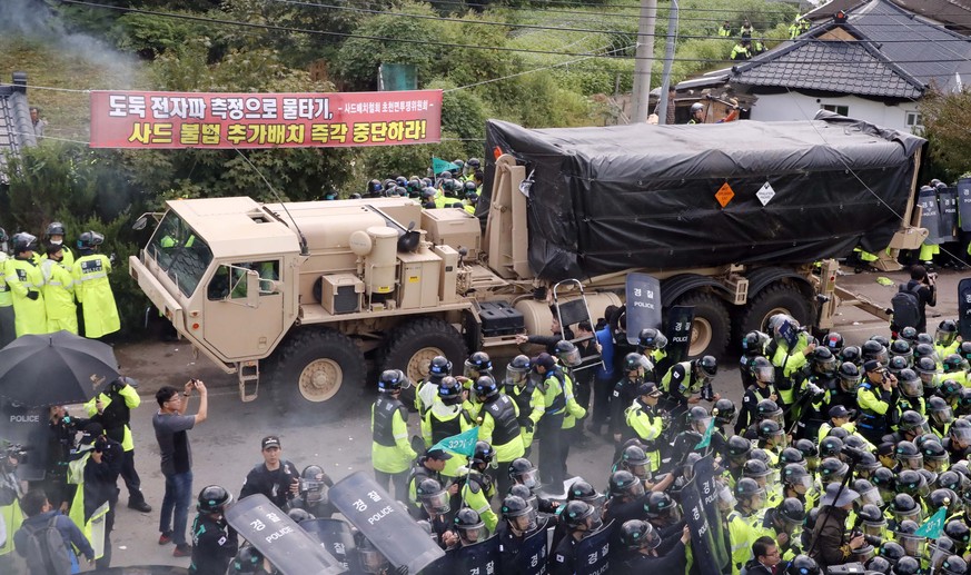 U.S. military vehicle moves as South Korean police officers try to block residents and protesters who oppose to deploy an advanced U.S. missile defense system called Terminal High-Altitude Area Defens ...