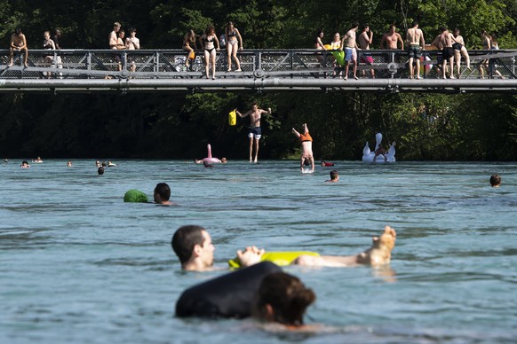 People enjoy the sun on the Aare River between Thun and Bern, Switzerland, during the sunny and warm weather, Sunday, June 30, 2019. The forecast predicts hot weather in Switzerland with maximum tempe ...