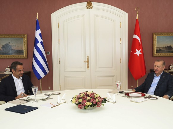 In this photo provided by Turkish Presidency, Greek Prime Minister Kyriakos Mitsotakis, left, talks to Turkish President Recep Tayyip Erdogan during their meeting in Istanbul, Turkey, Sunday, March 13 ...