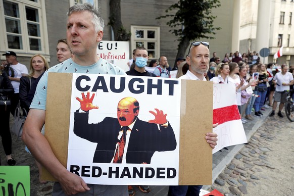 epa08599617 People stage a picket to support the part of Belarusian society, who oppose the results of the Belarus Presidential elections, at the front of Belarus embassy in Riga, Latvia, 12 August 20 ...