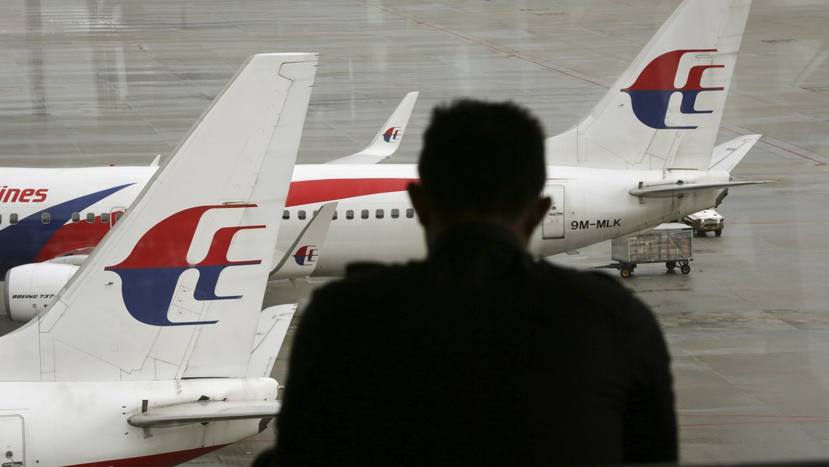 A visitor looks out from the viewing gallery as Malaysia Airlines aircraft sit on the tarmac at the Kuala Lumpur International Airport (KLIA) in Sepang, Malaysia, Tuesday, May 27, 2014. The Malaysian  ...