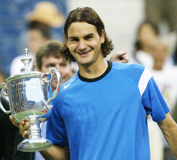 Roger Federer, of Switzerland, poses with the championship trophy after defeating Lleyton Hewitt, of Australia, in the men's singles final at the U.S. Open tennis tournament in New York, Sunday,  ...