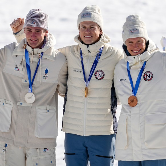 Silver medalist Mathis Desloges, of France, gold medalist Johannes Hoesflot Klaebo, of Norway, and bronze medalist Martin Loewstroem Nyenget, of Norway, from left, pose on the podium of the cross coun ...