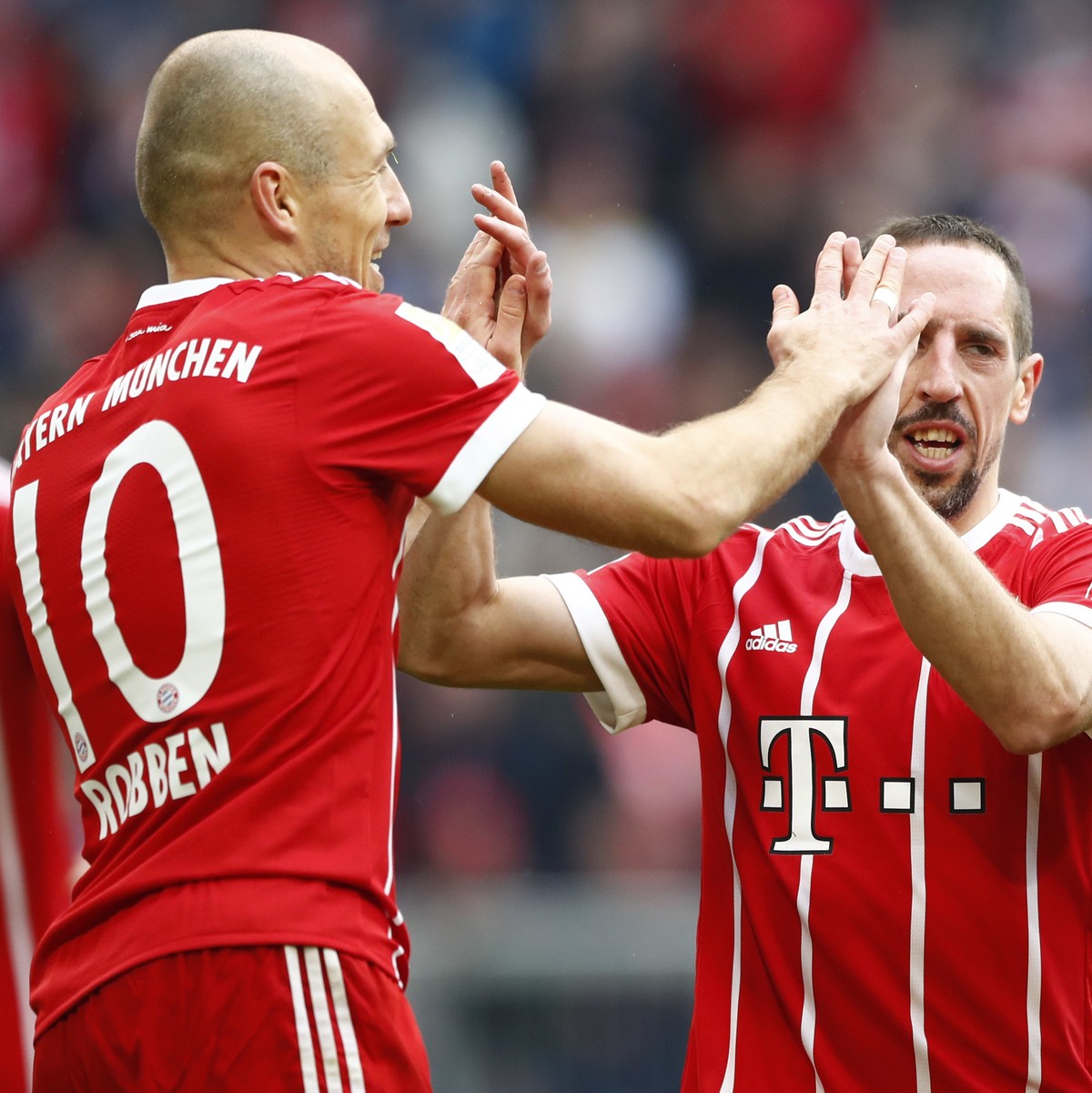 Bayern's Arjen Robben, left, celebrates with team mates Franck Ribery, center, and Corentin Tolisso after scoring his side's fourth goal during the German Soccer Bundesliga match between FC  ...