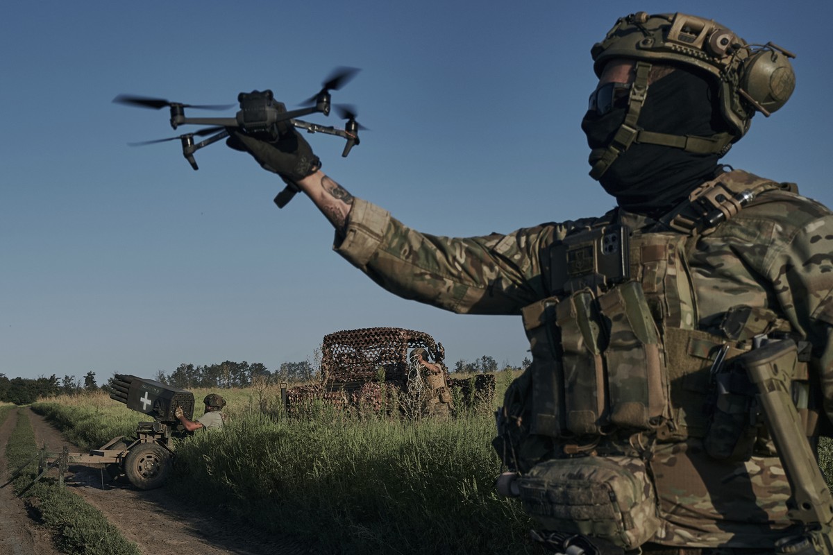 A Ukrainian soldier of the 28th brigade launches a drone at the frontline close to Bakhmut, Ukraine, Sunday, Aug. 20, 2023. (AP Photo/Libkos)
