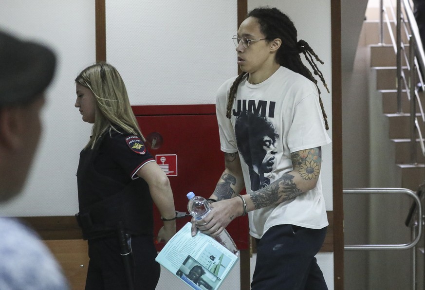 epa10045431 Two-time Olympic gold medalist and WNBA player Brittney Griner (R) is escorted to a courtroom for a hearing, in Khimki City Court, outside Moscow, Russia, 01 July 2022. The Khimki City Cou ...