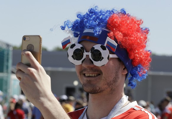 A fan takes a photo prior to the group E match between Costa Rica and Serbia at the 2018 soccer World Cup in the Samara Arena in Samara, Russia, Sunday, June 17, 2018. (AP Photo/Mark Baker)