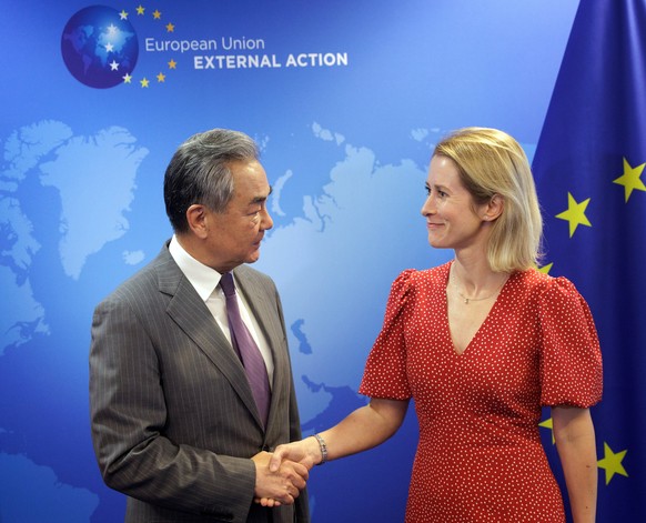 epa12210376 European Union&#039;s High Representative for Foreign Affairs and Security Policy, Kaja Kallas (R) shakes hands with Chinese Foreign Minister Wang Yi (L) during his visit to the EU institu ...