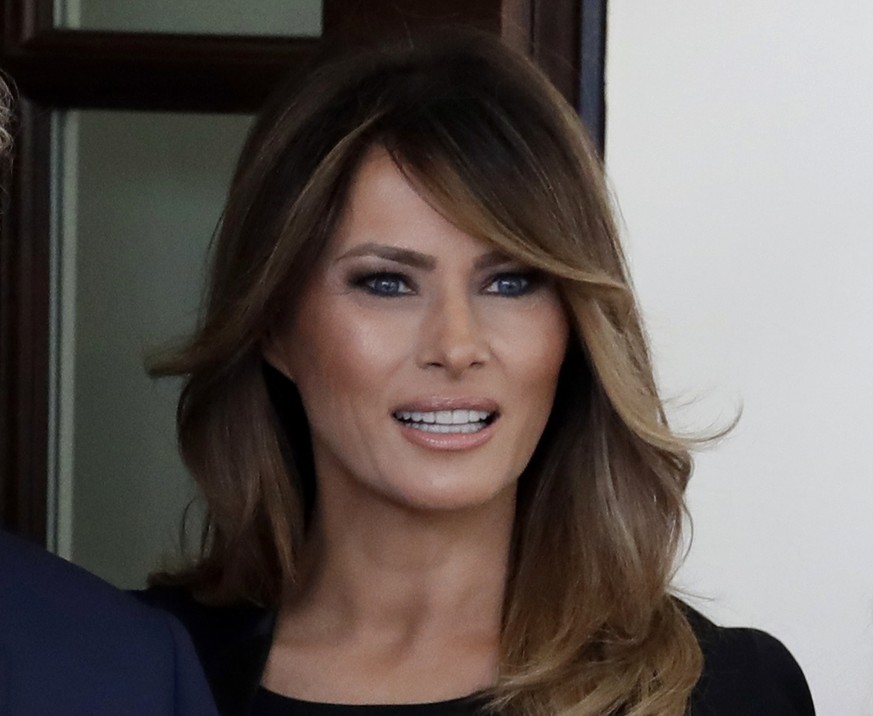 FILE - In a Monday, April 23, 2018 file photo, first lady Melania Trump greet French President Emmanuel Macron and his wife Brigitte Macron at the White House, in Washington. he White House says Melan ...