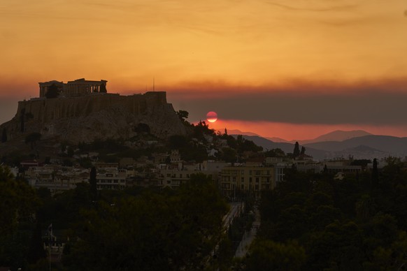 The sun sets behind the Acropolis hill as smoke from a nearby wildfire fills the sky during a heatwave in Athens, Greece, Saturday, July 26, 2025. (AP Photo/Petros Giannakouris)
APTOPIX Greece Heat Wa ...