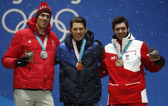 Medalists in the men&#039;s slalom, from left, Switzerland&#039; Ramon Zenhaeusern, silver, Sweden&#039;s Andre Myhrer, gold, and Austria&#039;s Michael Matt, bronze, pose during their medals ceremony ...