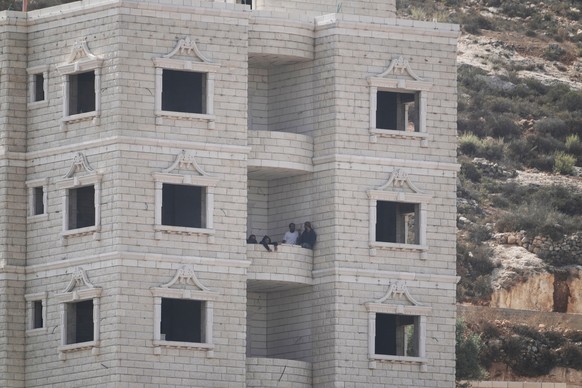 Israeli settlers are seen inside a Palestinian building under construction in the occupied West Bank village of Qusra, Saturday, Aug. 29, 2026. (AP Photo/Majdi Mohammed)
Israel Palestinians