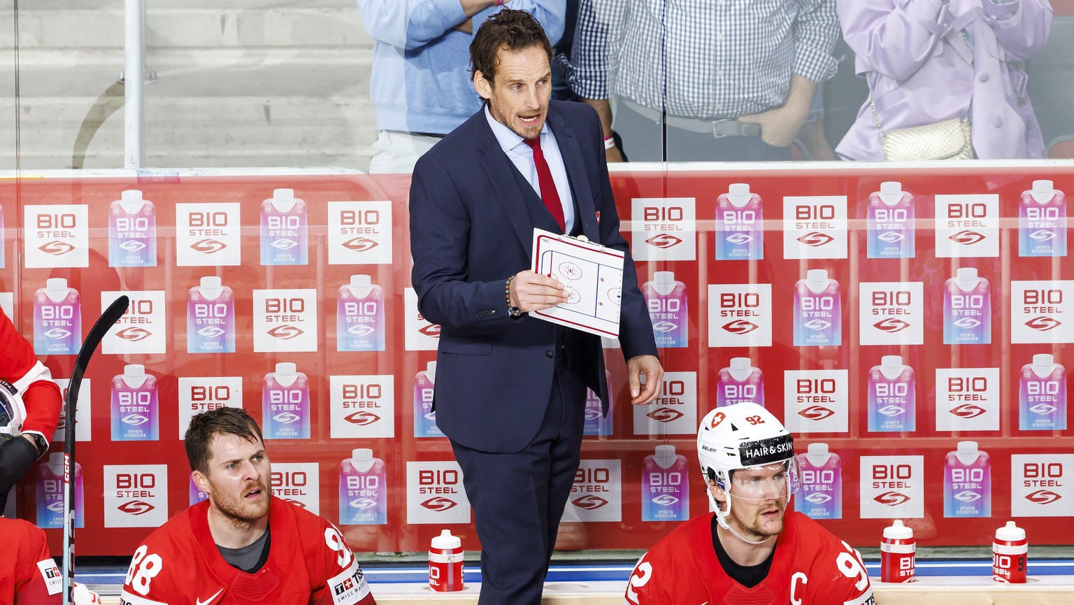 Patrick Fischer, left, head coach of Switzerland national ice hockey team, reacts, during the IIHF 2023 World Championship preliminary round group B game between Switzerland and Latvia, at the Riga Ar ...