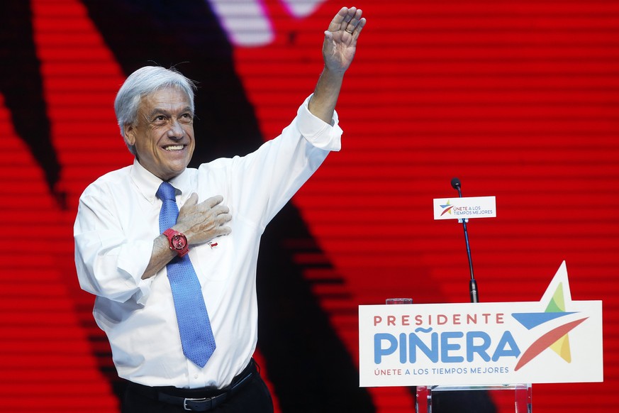 epa06390482 Right-wing presidential candidate Sebastian Pinera greets his supporters during a closing campaign rally at the Caupolican Theater in Santiago, Chile, 14 December 2017. The second round of ...