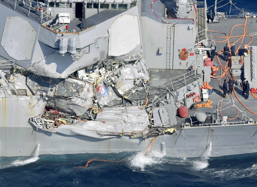 The damage of the right side of the USS Fitzgerald is seen off Shimoda, Shizuoka prefecture, Japan, after the Navy destroyer collided with a merchant ship, Saturday, June 17, 2017. Seven Navy sailors  ...