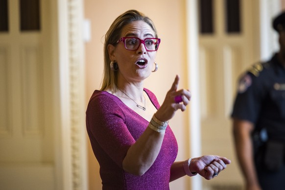 epa09344640 Democratic Senator from Arizona Kyrsten Sinema expresses her displeasure with the media after the newspaper Roll Call ran a photograph of her wearing a hands-free crutch, with the headline ...