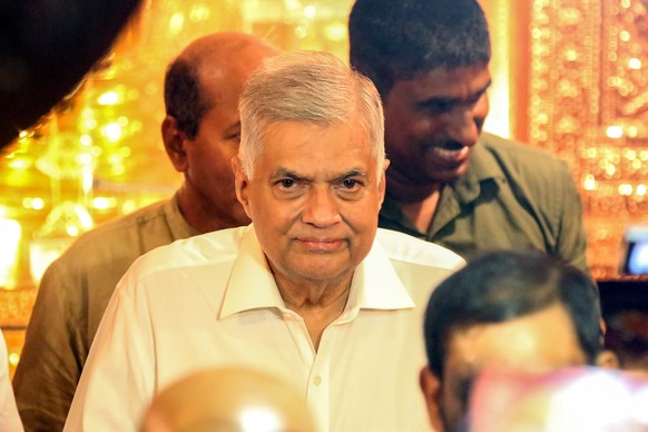 epa10061665 (FILE) - Sri Lankan newly appointed prime minster Ranil Wickremesinghe (C) arrives to the Buddhist temple in Colombo, Sri Lanka, 12 May 2022 (reissued 09 July 2022). Sri Lankan Prime Minis ...