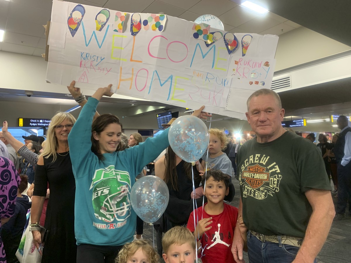 Danny Mather, right, and other family members wait at the Wellington International Airport for the arrival of Mather's pregnant daughter Kristy in Wellington, New Zealand Monday, April 19, 2021.  ...