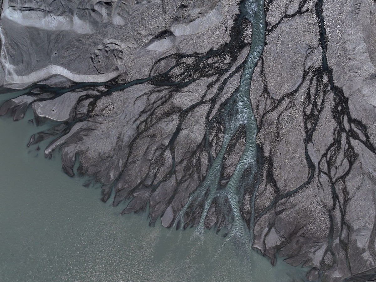 KANGERLUSSUAQ, GREENLAND - JULY 11: In this aerial view fingers of meltwater flow from the melting Isunnguata Sermia glacier descending from the Greenland Ice Sheet on July 11, 2024 near Kangerlussuaq ...