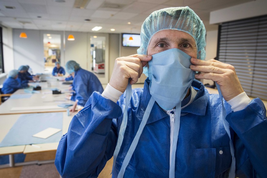 epa08310049 Employees make face masks at the Wilhelmina Hospital in Assen, The Netherlands, 20 March 2020. The sterile medical assistant found a solution to the shortage of mouth masks. Countries arou ...