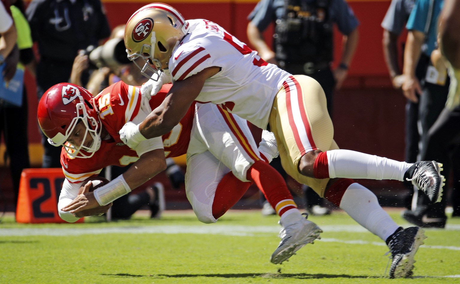 Kansas City Chiefs quarterback Patrick Mahomes (15) is tackled by San Francisco 49ers linebacker Malcolm Smith (51) during the first half of an NFL football game in Kansas City, Mo., Sunday, Sept. 23, ...