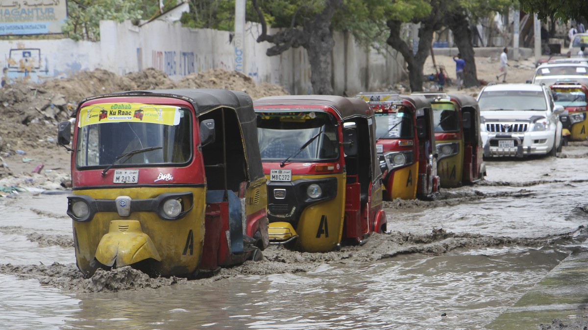 Tuktuks pass through a flooded road after heavy rain in Mogadishu, Somalia, Monday, Nov. 13, 2023. Since October, floods caused by torrential rainfall have displaced nearly half a million people and d ...