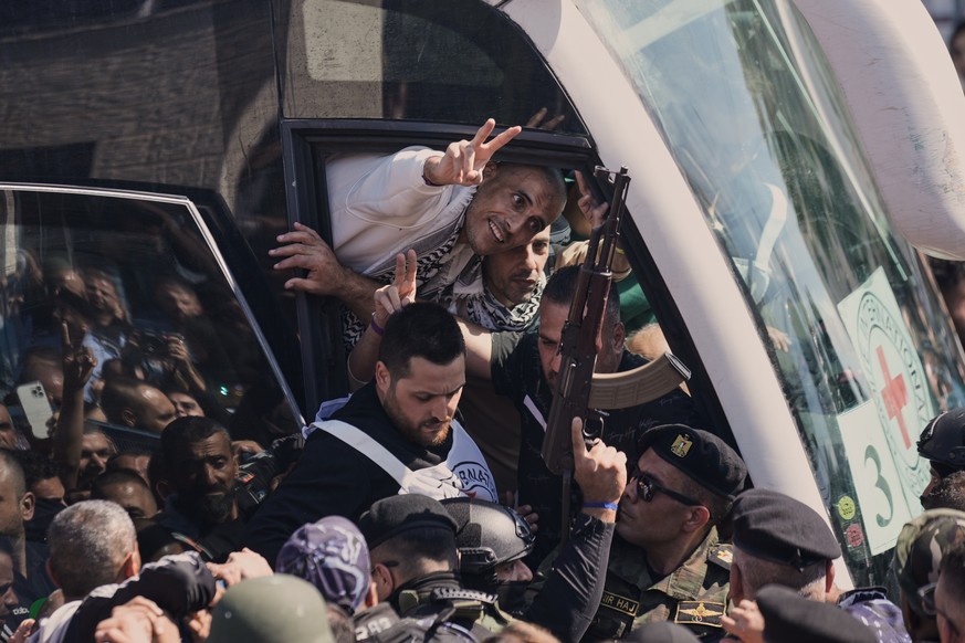 A Palestinian prisoner makes the victory sign after being released from an Israeli prison as part of a ceasefire deal between Israel and Hamas, upon his arrival in the West Bank city of Ramallah, Mond ...