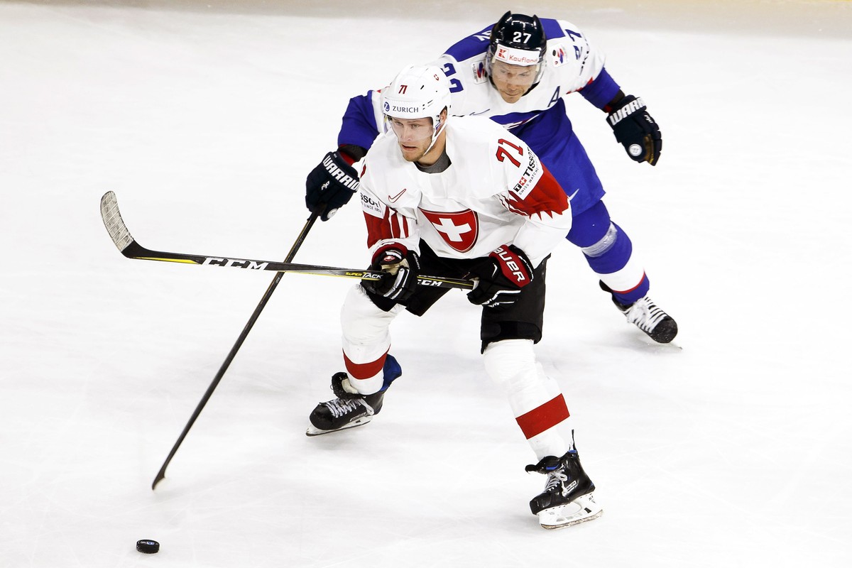 epa06715813 Switzerland's forward Enzo Corvi (front) in action against Slovakia's forward Ladislav Nagy (back) during the IIHF World Championship Group A ice hockey match between Slovakia an ...