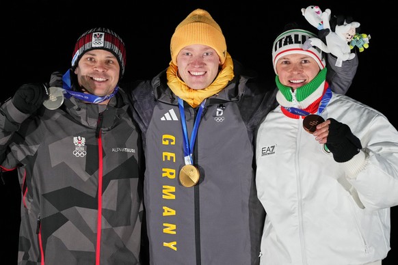 From left, second placed Austria's Jonas Mueller, first placed Germany's Max Langenhan and third placed Italy's Dominik Fischnaller pose with their medals after the men's single lu ...