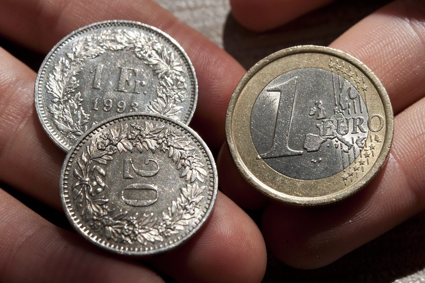 Coins of 1 Euro, right, and coins of 1 Swiss Franc and 20 centime, left, pictured in Lausanne, Switzerland, Tuesday, September 6, 2011. - Die Schweizerische Nationalbank (SNB) haelt am Euro-Mindestkur ...