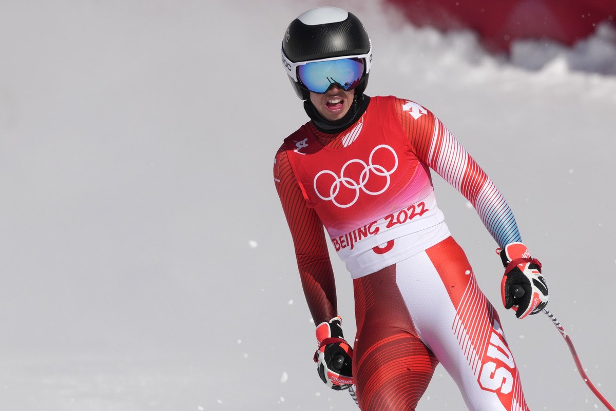 Michelle Gisin, of Switzerland reacts after finishing women's downhill training at the 2022 Winter Olympics, Monday, Feb. 14, 2022, in the Yanqing district of Beijing. (AP Photo/Luca Bruno)