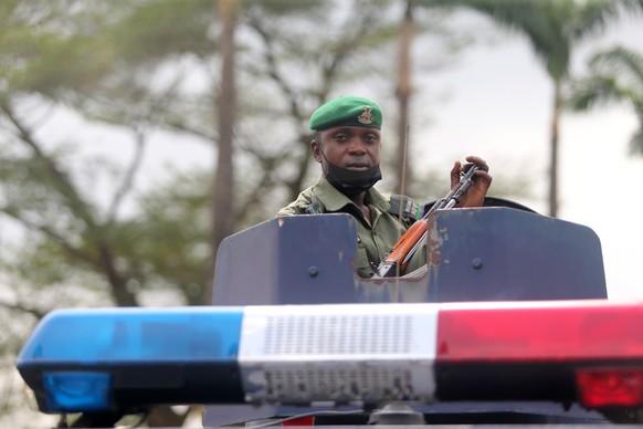 epa09065843 A policeman sits on a police amoured vehicle as he holds a gun, during a protest by the Nigeria Labour Congress (NLC) members, ahead of a planned nation-wide strike by the NLC, in Ikeja di ...