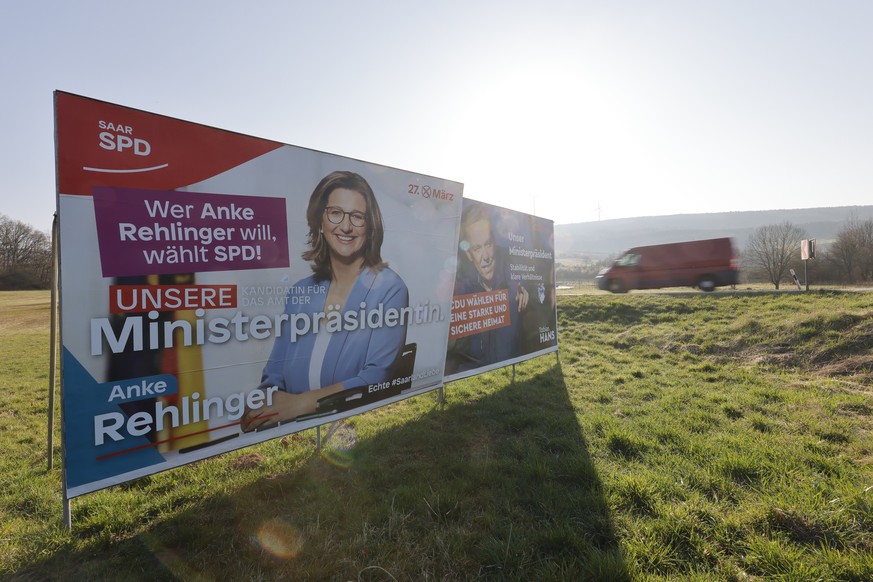 epa09852474 Campaign posters of the top candidates for the regional elections in Saarland of the Social Democratic Party (SPD) Anke Rehlinger (L), and Tobias Hans (R) of the Christian Democratic Union ...