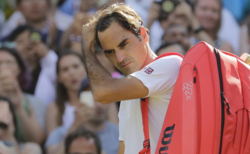 Switzerland&#039;s Roger Federer prepares to leave the court after losing his men&#039;s quarterfinals match against Kevin Anderson of South Africa, at the Wimbledon Tennis Championships, in London, W ...