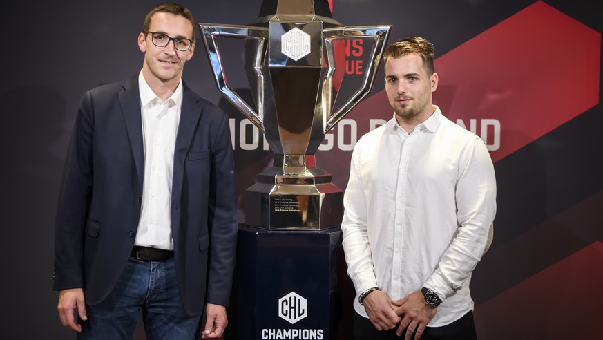 HC Ambri-Piotta Head Coach Luca Cereda, left, and HC Ambri-Piotta Player Marco Mueller, right, take a pose next to the CHL Cup during a press conference about the current developments of the Champions ...