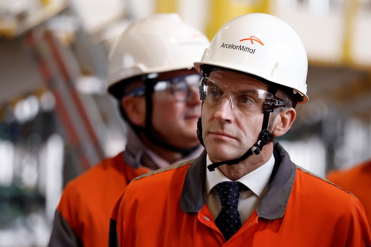 epa12722746 French President Emmanuel Macron, wearing a working helmet, visits the Mardyck Electryck site dedicated to the electric steel production at one of steelmaker ArcelorMittals plants in Dunk ...