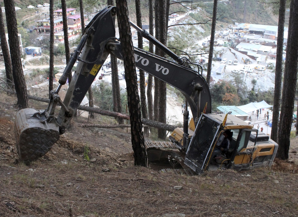 An earth-mover makes a vertical drill on the top of a mountain where a tunnel that collapsed in Uttarakhand state, India, Saturday, Nov. 18, 2023. Forty workers were trapped in the collapsed road tunn ...