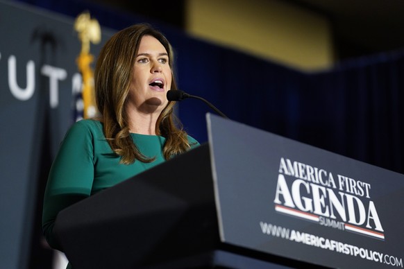 Former White House press secretary Sarah Huckabee Sanders speaks before former President Donald Trump at an America First Policy Institute agenda summit at the Marriott Marquis in Washington, Tuesday, ...