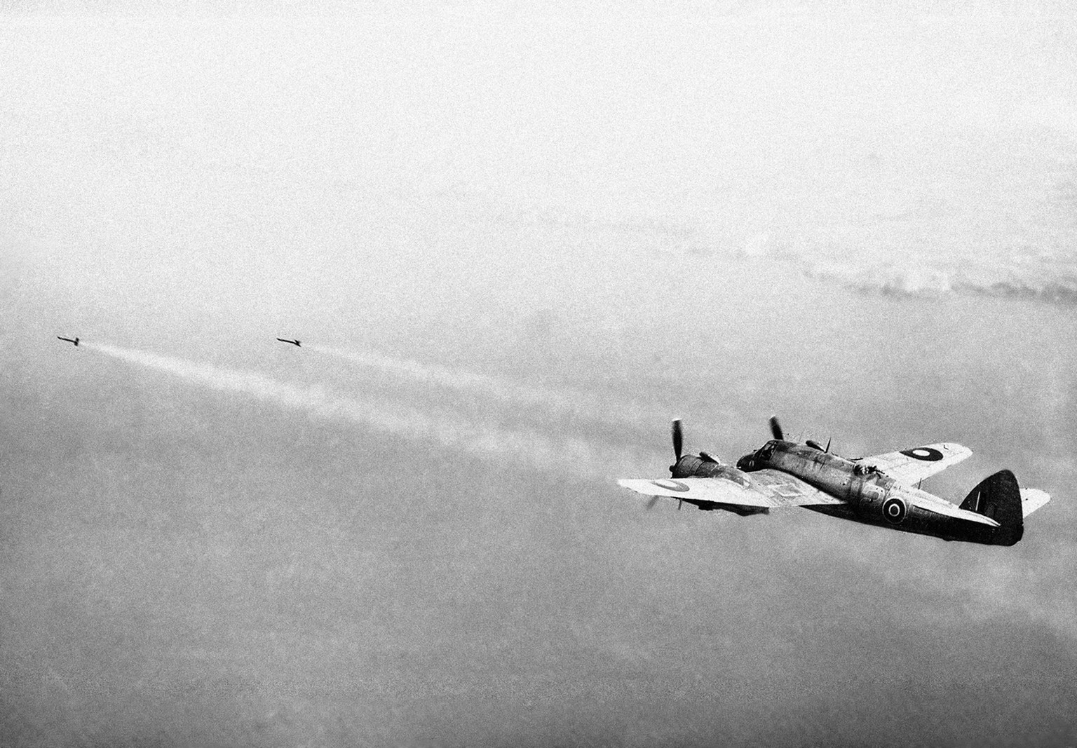Beaufighters of Royal Air Force Coastal Command have been attacking enemy shipping off the Norwegian and Dutch coasts with a new weapon, the Rocket projectiles. Streaking ahead of the Beaufighter, a p ...
