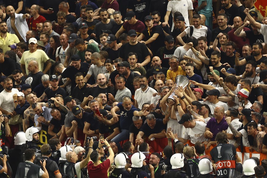 Roma supporters celebrate with the trophy after the Europa Conference League final soccer match between AS Roma and Feyenoord at the National Arena stadium in Tirana, Albania, Wednesday, May 25, 2022. ...