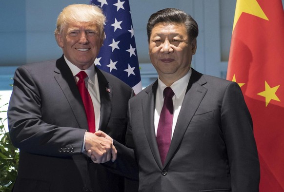 US President Donald Trump and Chinese President Xi Jinping, right, shake hands as they arrive for a meeting on the sidelines of the G-20 Summit in Hamburg, Germany, Saturday, July 8, 2017. (Saul Loeb/ ...