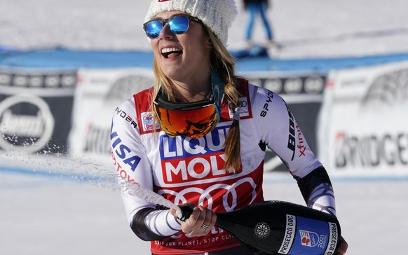 FILE - In this Sunday, Jan. 20, 2019 filer, United States&#039; Mikaela Shiffrin sprays sparkling wine as she celebrates after winning an alpine ski, women&#039;s World Cup super-G in Cortina D&#039;A ...