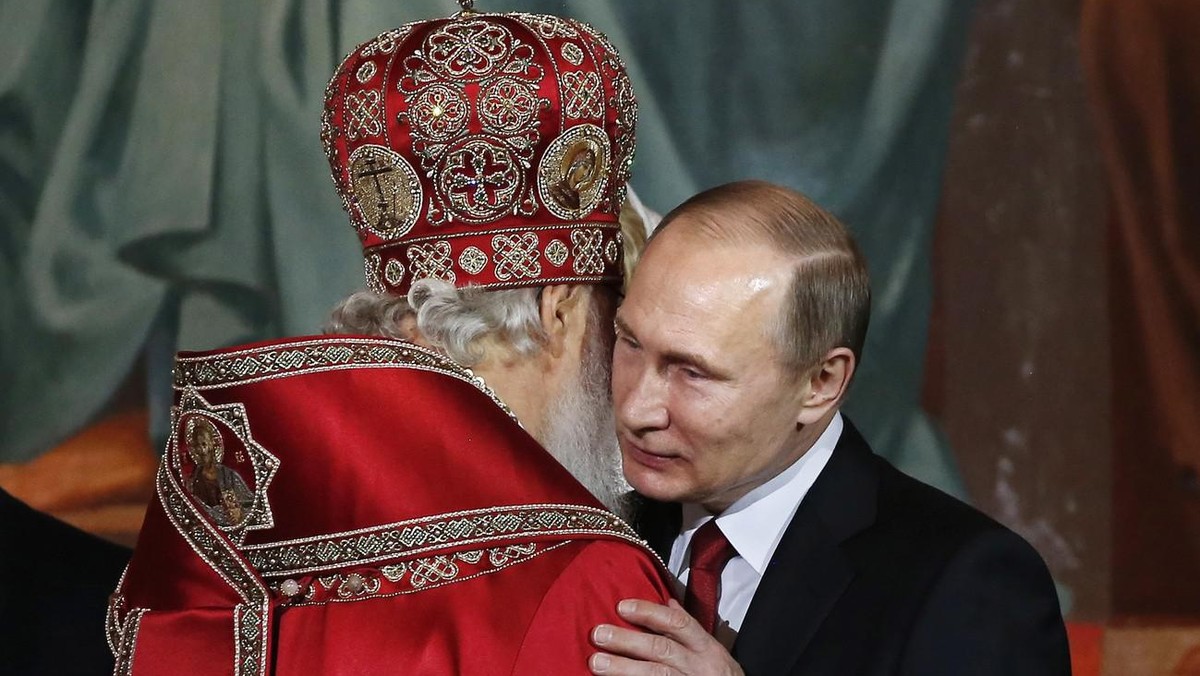 Patriarch of Moscow and All Russia Kirill (L) kisses Russian President Vladimir Putin (R) as they congratulate each other during the Orthodox Easter holiday service in Moscow's Christ the Savior  ...