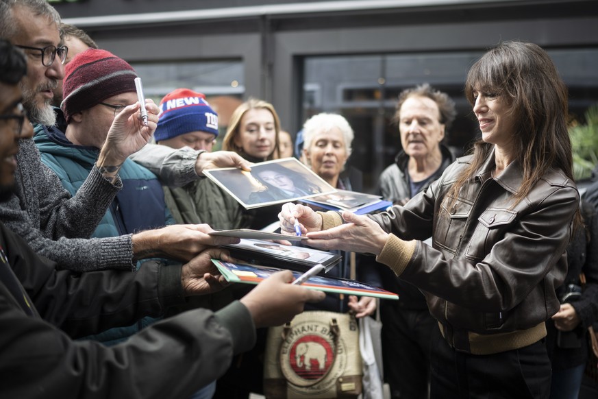epa10207452 British-French actress Charlotte Gainsbourg (R) signs for fans before the ZFF Masters talks during of the 18th Zurich Film Festival (ZFF) in Zurich, Switzerland, 26 September 2022. The ZFF ...