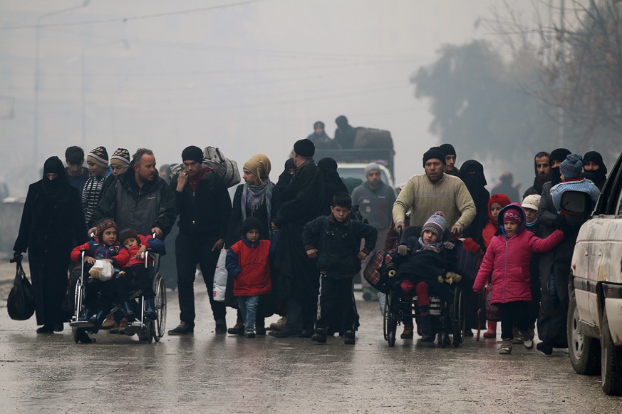 People walk as they flee deeper into the remaining rebel-held areas of Aleppo, Syria December 13, 2016. REUTERS/Abdalrhman Ismail